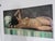 An original mid-century oil on canvas depicting a reclining female nude rendered with expressive, painterly brushwork and...