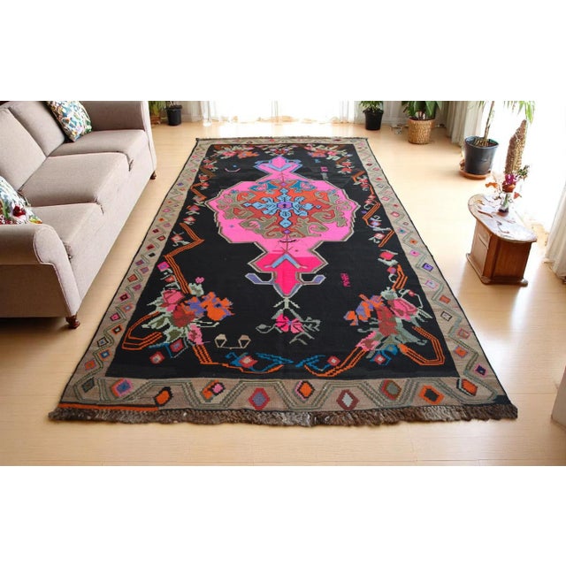 Enhance your living space with this stunning vintage handmade flat weave Turkish kilim rug from the 1970s. The candy pink...