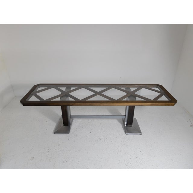 Dining table (260 cm x 80 cm) with a chromed metal and oak base. The glass top is set in a carved oak frame that...