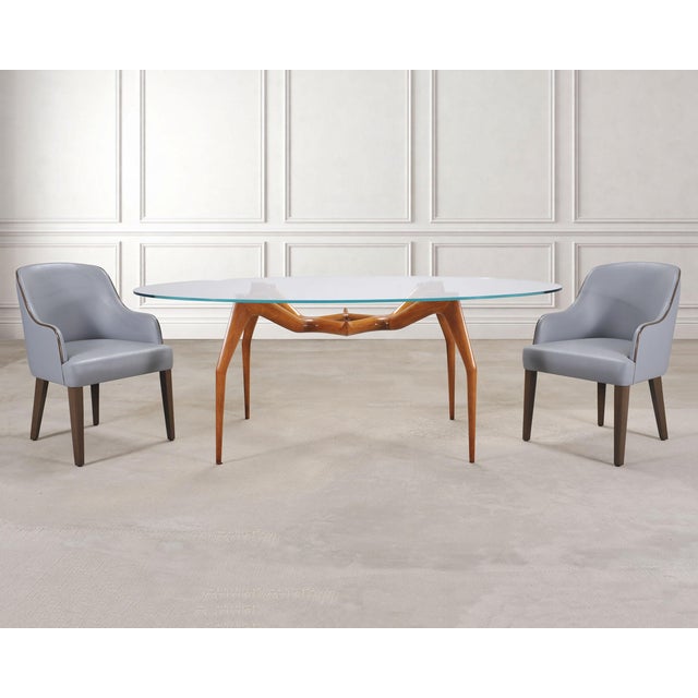 A refined set of six A. Rudin “No. 807” dining chairs, consisting of two host armchairs finished in vegan leather and four...