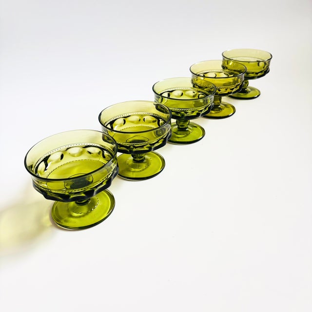 A set of 5 gorgeous coupe glasses with a lovely ornate design in green glass. Made in the King's Crown pattern by Indiana...
