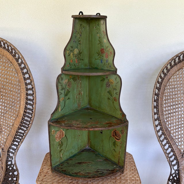 Lovely 19th century 3 tier wooden corner wall shelf. Painted in the prettiest shade of green with marvelous floral motifs....