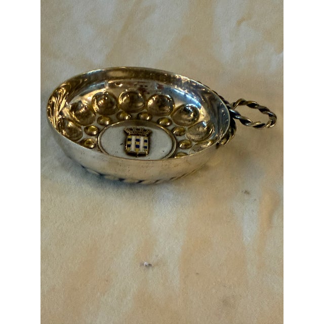 Antique French sterling silver wine taster (tastevin) featuring an intricate circular design with a central insignia or...