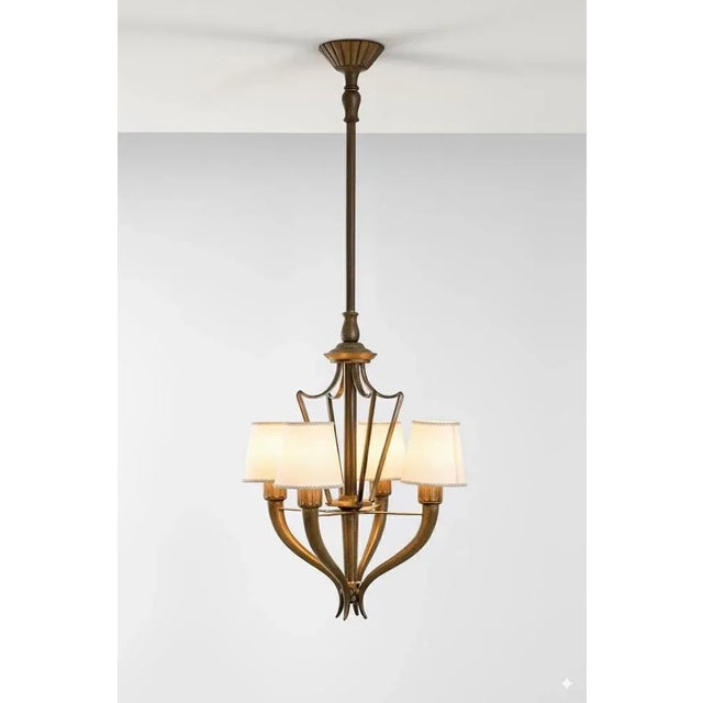 An elegant bronze chandelier by Italian architect and designer Emilio Lancia (1890-1973) for Officine Italo Carlotti....