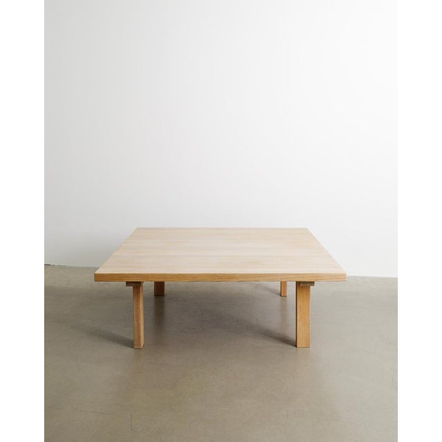 A very beautiful squared Danish mid century modern coffee table with four asymmetrical legs and a squared top in stained...