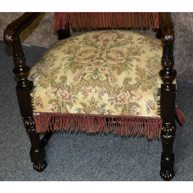 Antique (1920s) High Back Chair has a Tudor Style. The Frame is Wood. Made of Carved Oak with a Stretcher Base. Multicolor...