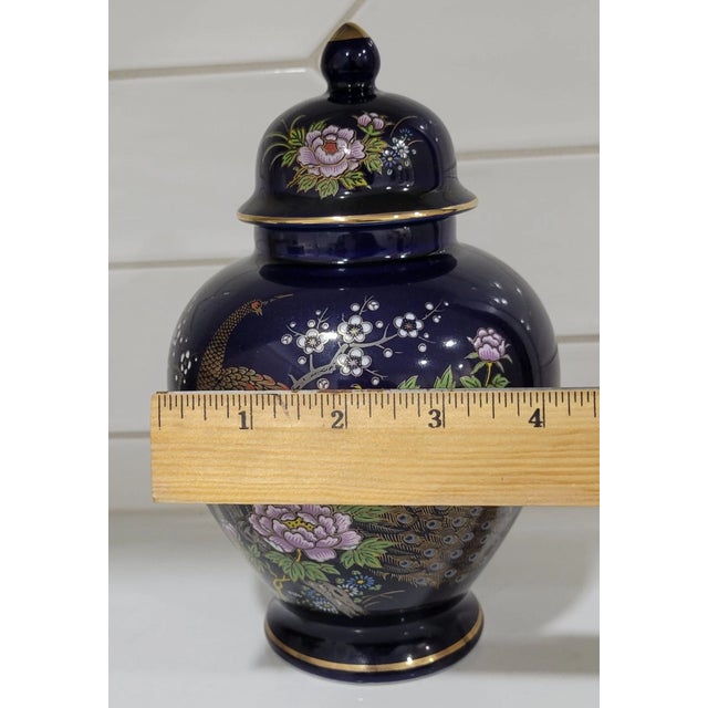 Add a touch of timeless elegance to your décor with this beautiful vintage cobalt blue ginger jar, expertly decorated with...