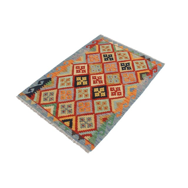 Add a touch of elegance to your home with this casual chic hand woven Tribal Kilim wool rug. Constructed on a loom by...