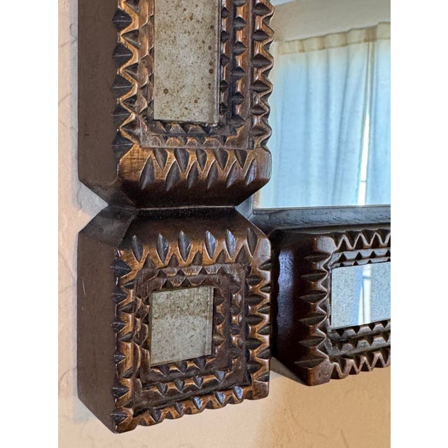 Currey & Co. handcrafted square wood framed mirror from the Tramp Art collection.. Textural thick carved wood frame with...