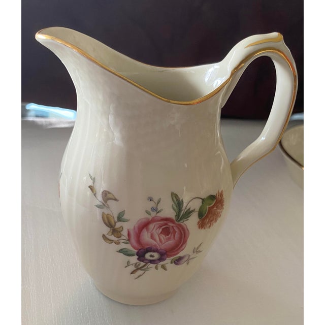 A beautiful porcelain 1950's vintage sugar and creamer set by Royal Copenhagen in the Frijsenborg floral pattern. In great...