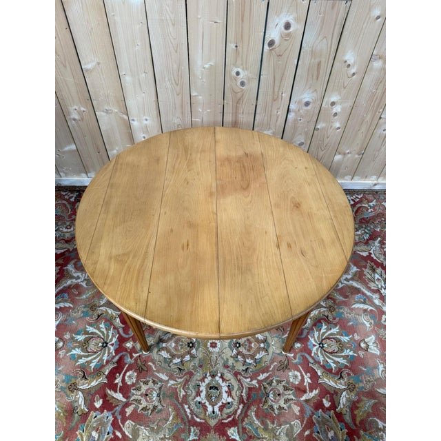 Magnificent round dining table in solid cherry wood, in the louis xvi style, meticulously restored. its circular top...