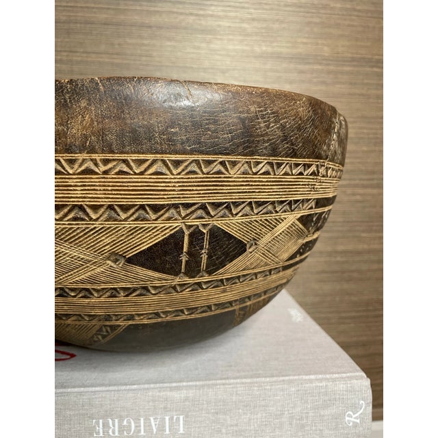 A stunning carved serving bowl from the nomadic Fulani people. With a signature intricate geometric pattern, this piece...