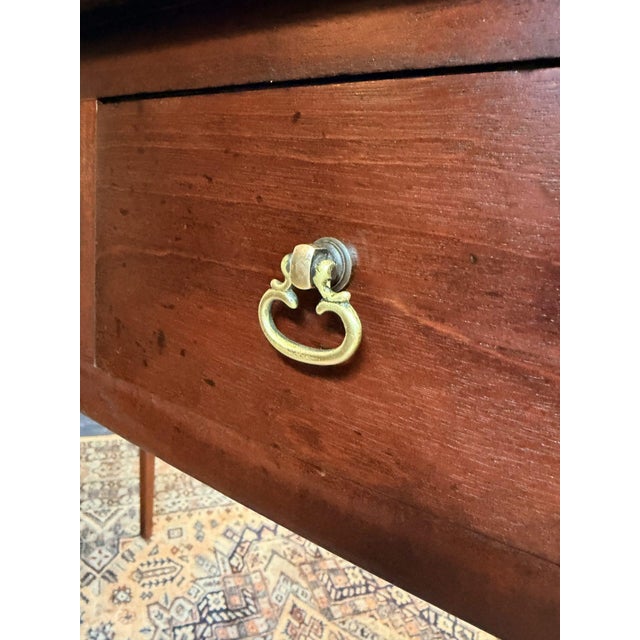 A very elegant antique mahogany bow fronted side table, featuring three drawers fitted with classic brass pulls. The...