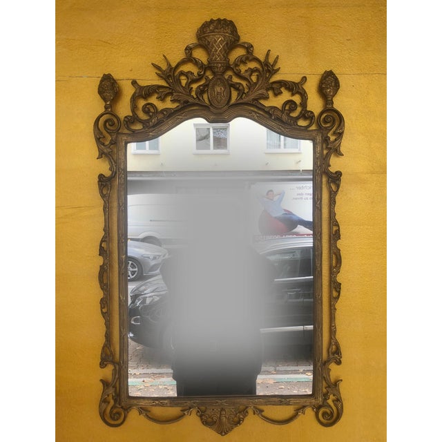 An exquisite, artfully designed wall mirror from italy, made in the baroque style, which reflects the opulent aesthetics...