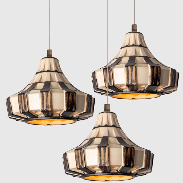 Stunning round hanging lamp with an unusual shape, made with rich brown and ivory striped ceramics, manufactured in the...