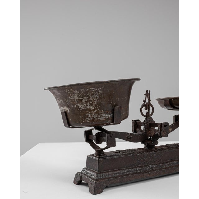 This 19th Century French iron scale displays a compelling blend of utilitarian design and sculptural presence, marked by...