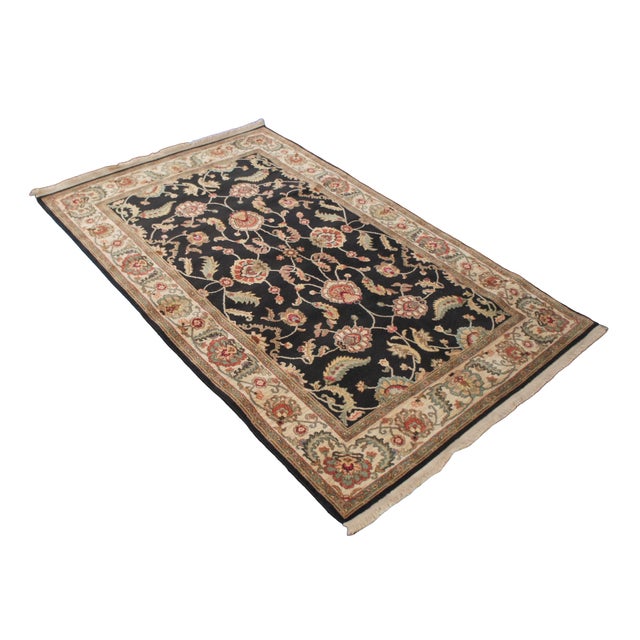 Vintage Karastan 100% wool area rug / mat / carpet featuring a floral motif inspired by palmettes and scrolled vines on a...