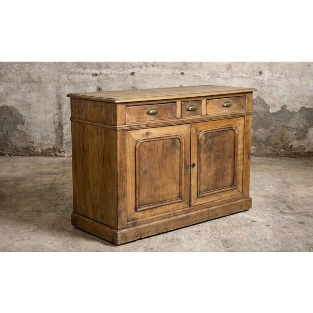 A handsome 19th-century French buffet, sourced in France, with beautifully restrained proportions, warm natural wood, and...