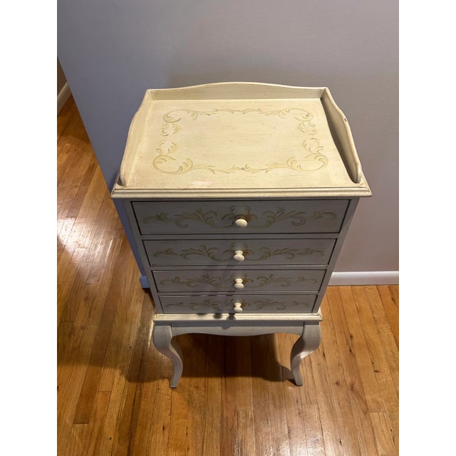 Has 4 velvet lined drawers to store your jewelry. Beautiful hand painted detailing. The muted colors will go with so many...