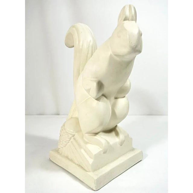 This charming Art Deco ceramic squirrel in cream by French artist Charles Lemanceau (1905-1980) is a stylized depiction...