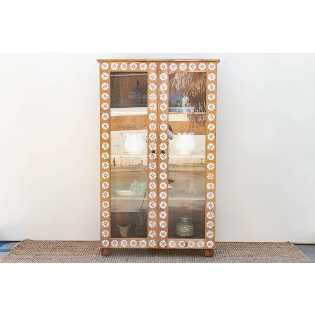 A charming bleached wood & mother of pearl inlay tall glass cabinet. Made from reclaimed teak, this large reconstructed...