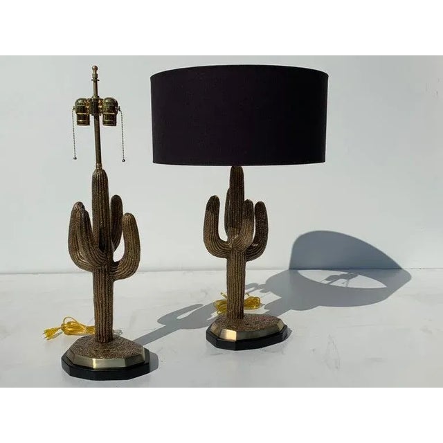 Pair of brass saguaro cactus lamps. Double cluster with max 60watt bulbs. Lampshade shown is 18" diameter by 8.5" high and...