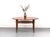 Iconic coffee table in solid teak by Peter Hvidt and Orla Mølgaard Nielsen for France & Søn. The removable woven shelf is...