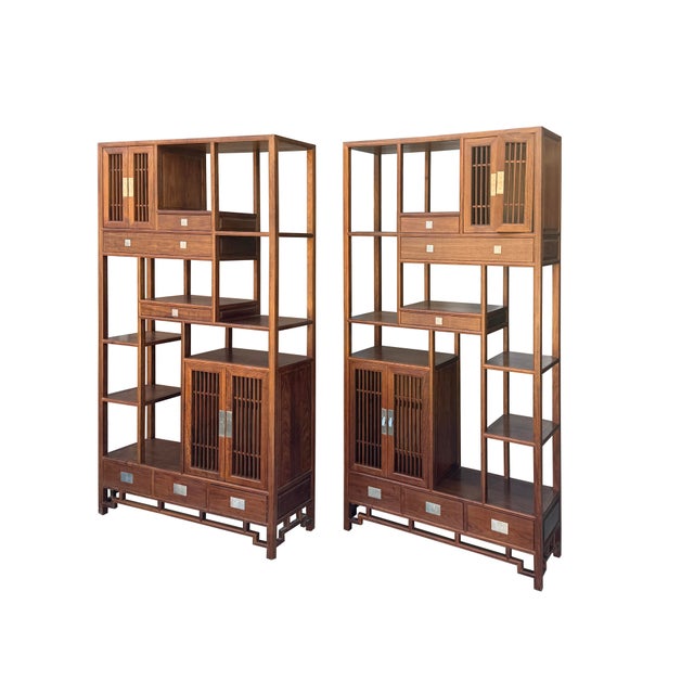 Elevate your space with this breathtaking pair of vintage Chinese Rosewood Asymmetrical Display Cabinets (Duobaoge)....