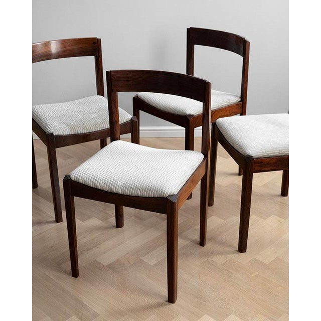 Set of 4 wooden dining chairs from the 1960s. The chairs have a wooden structure with rosewood veneer and new upholstery...