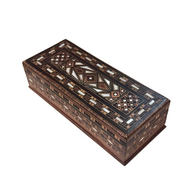 A beautiful vintage early 20th-century Middle Eastern decorative box, finely crafted with intricate wood marquetry and...