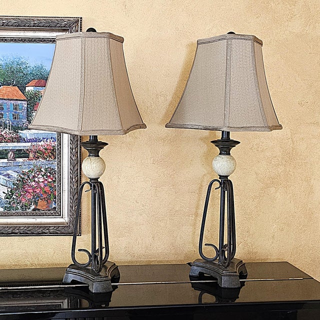 Matched pair of Uttermost table lamps, likely late 1990s–2000s, with Traditional/Old World styling and subtle...