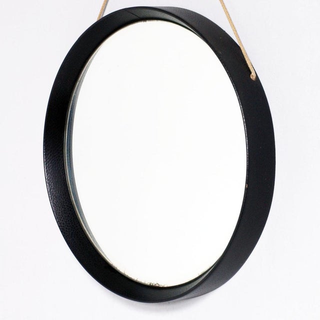 Round Wall Mirror, by Fontana Arte, wood frame leather covered, rope hanging. Very rare mirror of the Fontanit which was...
