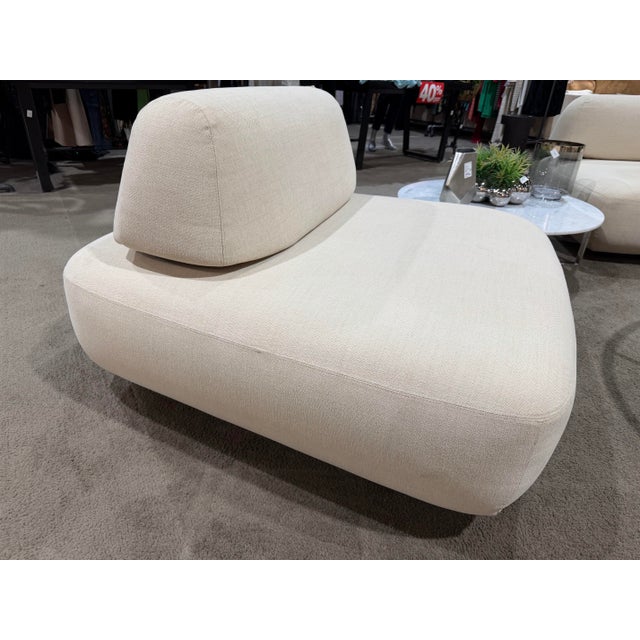 Effortlessly modern and sculptural in form, the Restoration Hardware “Isola” Armless Chair is a refined study in...