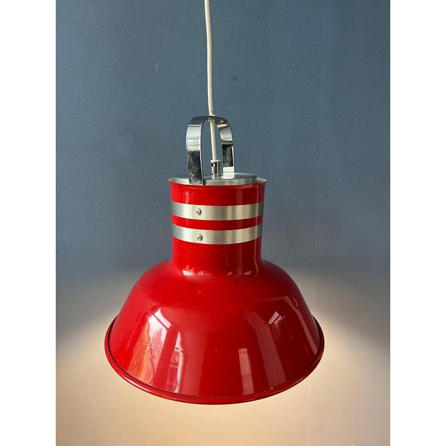 Red vintage space age 'bucket' pendant lamp by Ateljé Lyktan. The lamp has an industrial look and consists out of thick...