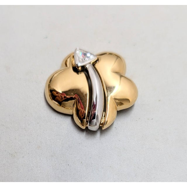 1980s goldtone cloud with rhodium plated arrow with a triangular clear rhinestone at the tip brooch with security clasp....