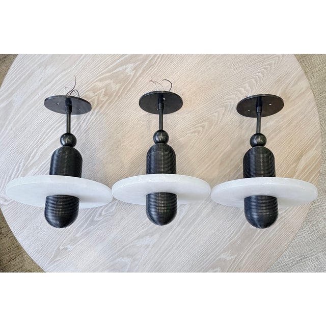 An exceptional set of three Median Mono pendants by acclaimed New York design studio Apparatus. Inspired by traditional...
