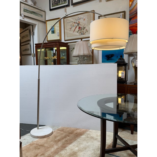 Design Plus Gallery presents the Meryl Arc Nickel Floor Lamp from Crate & Barrel. This contemporary statement piece...