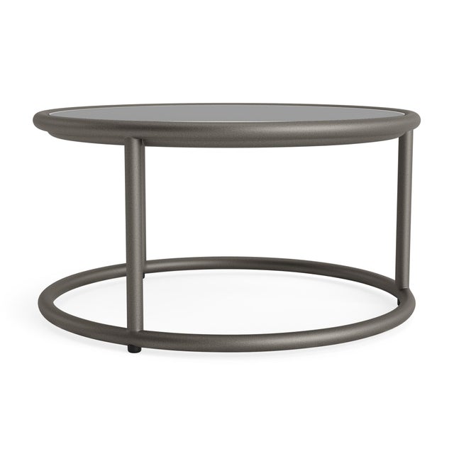 A free flowing frame design and transitional glass tabletop define the Walter Lamb Aluminum 20" Round Occasional Table....
