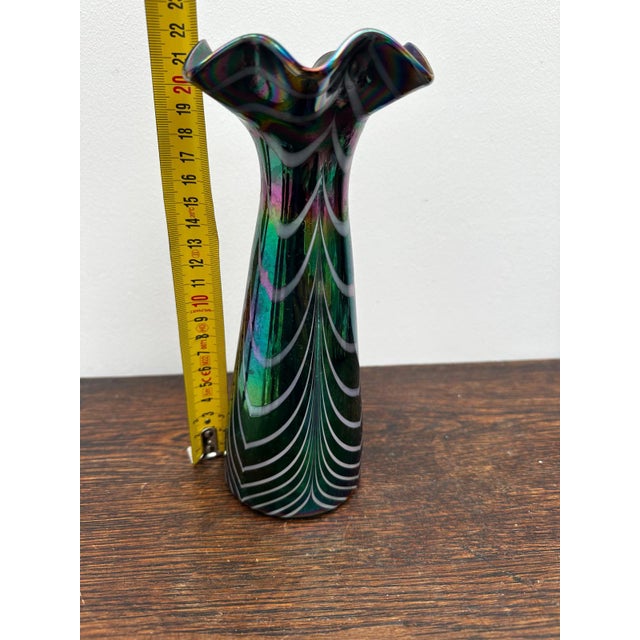 Iridescent blown glass vase with filigree decoration, Italy, 1970s. Its slender shape with a scalloped neck and elegant...