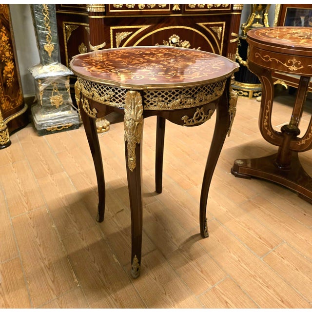An exquisite French Louis XV style accent table showcasing a beautifully crafted marquetry top, elegant cabriole legs, and...