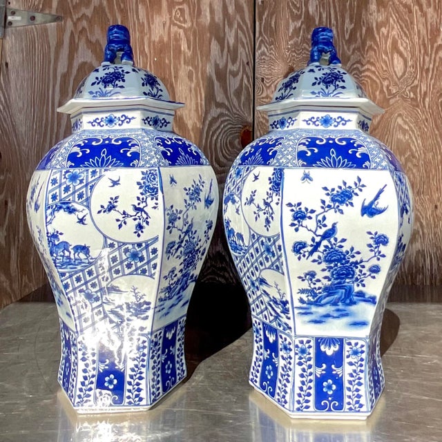 A fabulous pair of vintage Asian tall lidded urns. Beautiful iconic trellis design with love birds and flowers. Large and...