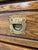 Oak Campaign Style Nightstands featuring dark wood grain, recessed brass-finish hardware, and a dark top surface....