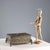 A chiseled bronze casket supported by four feet shaped like winged figures. All-over decoration of plant scrolls, birds,...