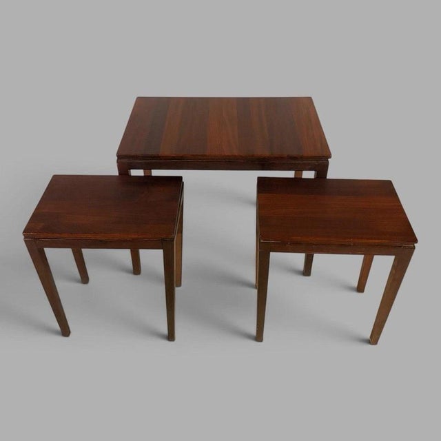 A highly practical british mid-century set of three afromosia teak nesting tables designed by richard hornby and...