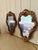 An elegant pair of Italian giltwood mirrors featuring richly carved Rococo frames with scrolling acanthus details and...