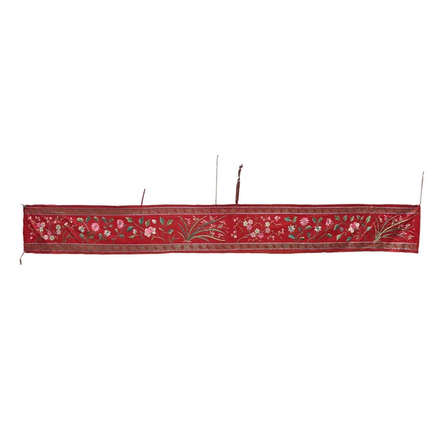 This vibrant vintage Chinese textile features a rich red ground meticulously embroidered with a continuous frieze of...