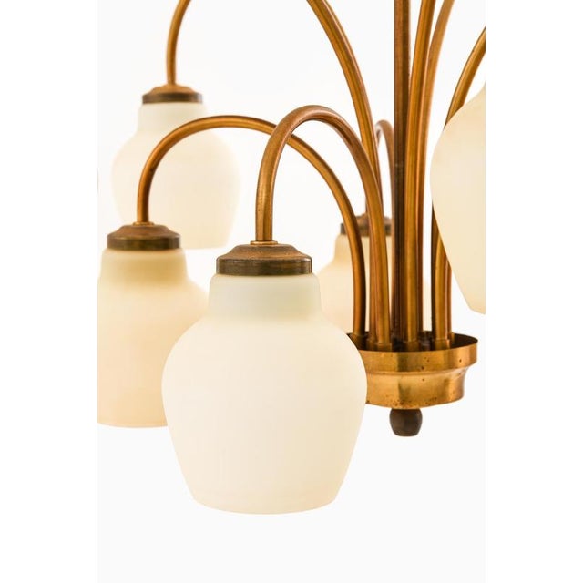 This ceiling lamp, designed by Ansgar Fog & Erik Mørup and produced by Fog & Mørup in Denmark during the 1940s, is a...