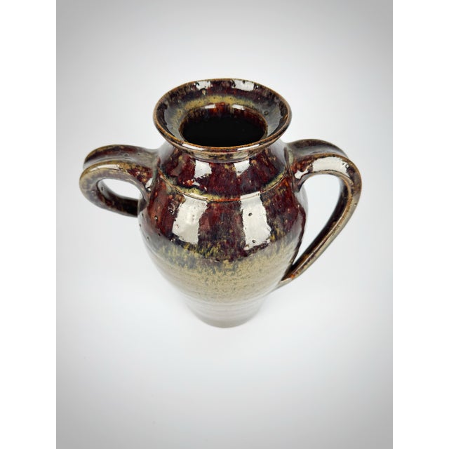 Hand-thrown vintage pottery jug by Hewell Pottery of Georgia, featuring a rich alkaline drip glaze in layered tones of...