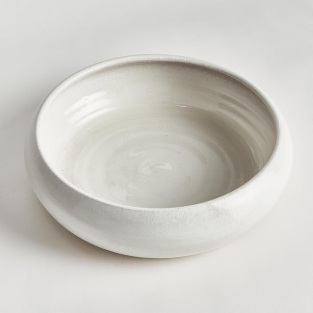 This terracotta low bowl is finished in a shinyWhite reactive glaze with a raw clay base, which is the natural touch that...