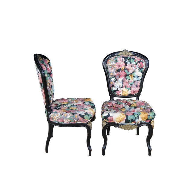 Set of four antique French Louis XV style dining chairs. Features an ebonized frame with Baroque ormolu mounts. The chairs...